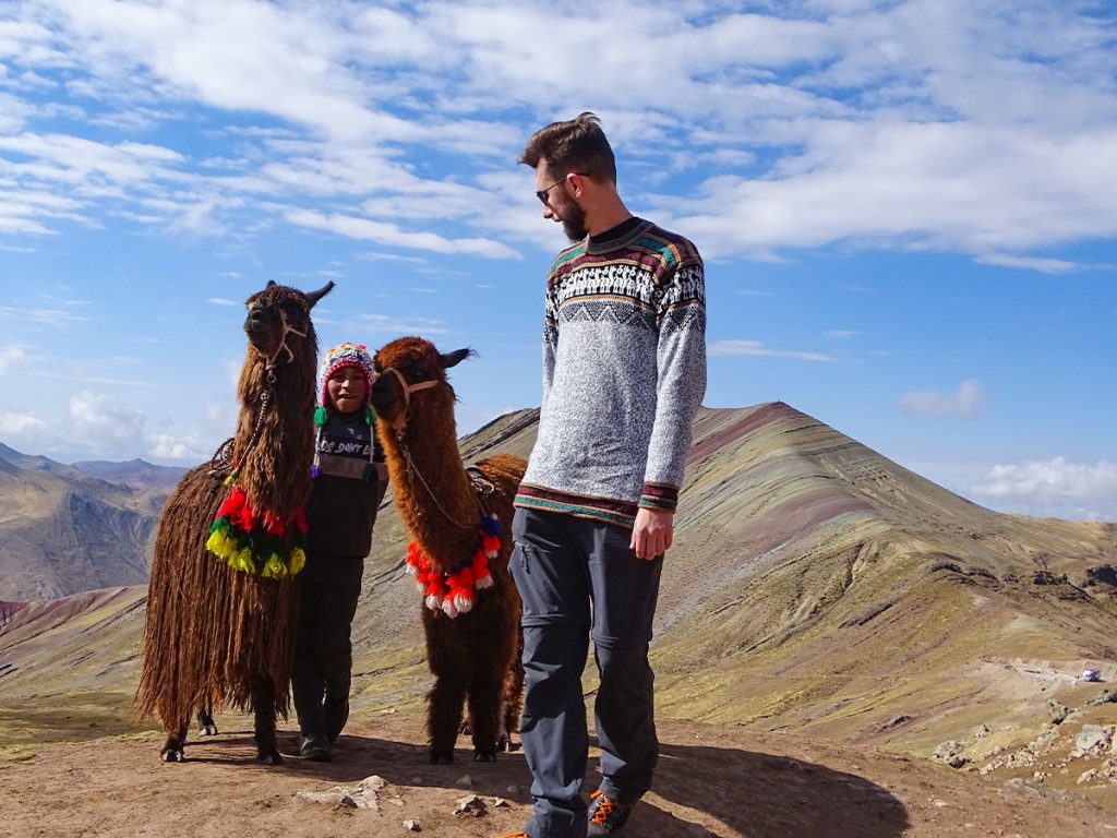 with alpaca in rainbow mountain